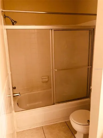 a bathroom with a shower and a toilet