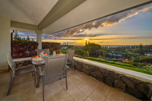 a view of a chairs and table in patio with a yard
