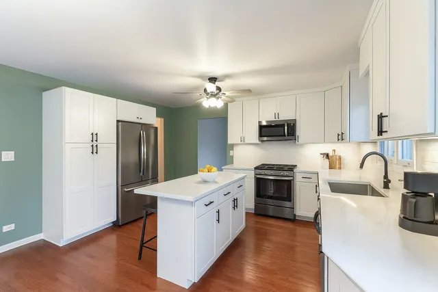 a kitchen with stainless steel appliances a refrigerator stove and sink