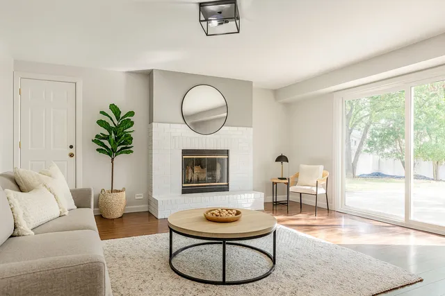 a living room with furniture a window and a fireplace