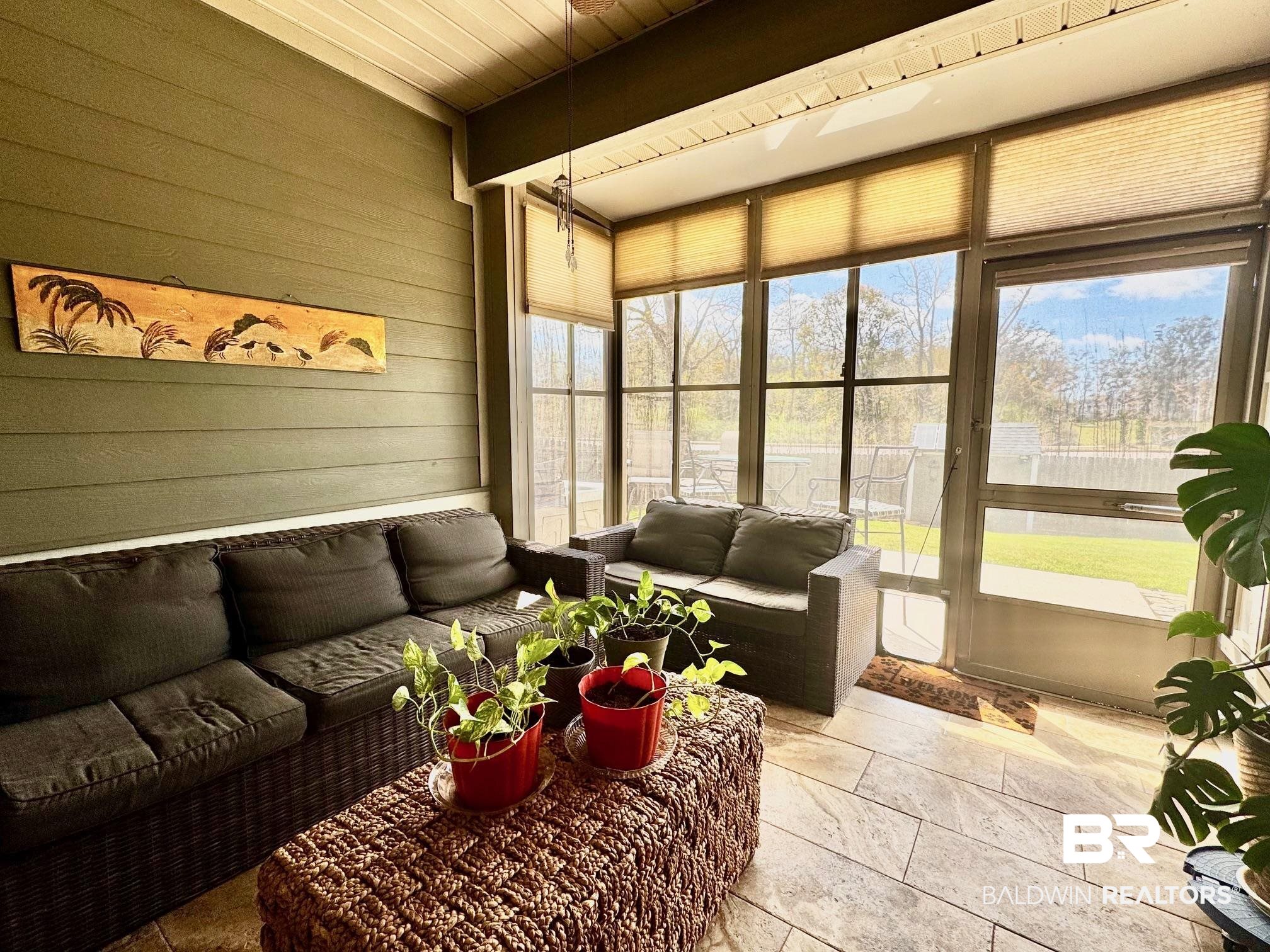 1030 Crown Walk Drive Foley, AL 36535 - Photo 30 of 40 Sunroom / solarium featuring plenty of natural light, wooden walls, and stone tile flooring