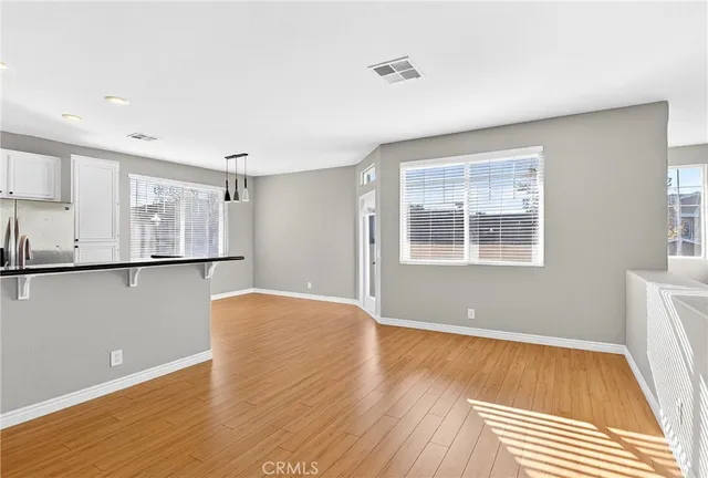 a view of a room with wooden floor and cabinet
