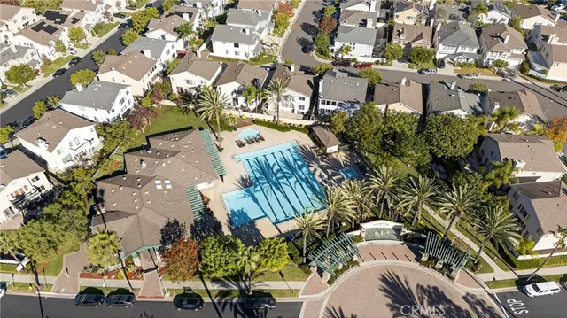a view of a swimming pool with a yard and potted plants