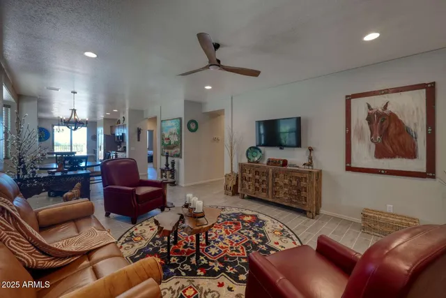 a living room with furniture ceiling fan and a rug