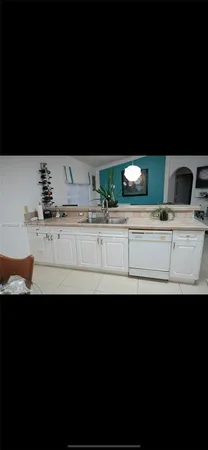 a view of kitchen sink and dishwasher with wooden floor