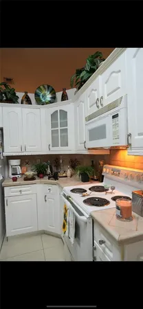 a bathroom with sink and view of bedroom