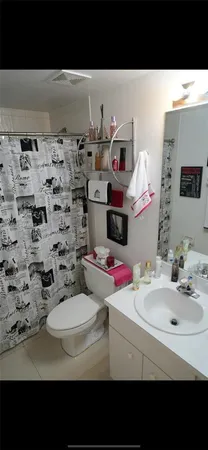 a bedroom with a bed and a night stand