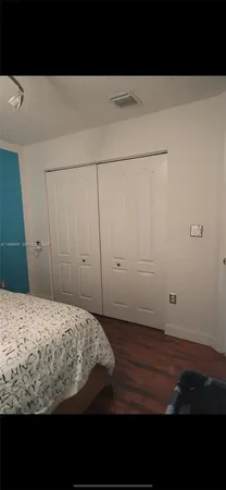 a view of a backyard with large tree