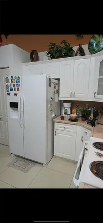a open kitchen with stainless steel appliances granite countertop a stove top oven and cabinets