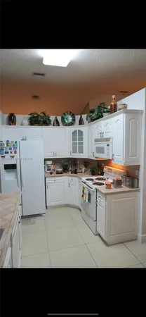 a open kitchen with stainless steel appliances granite countertop a stove top oven and cabinets