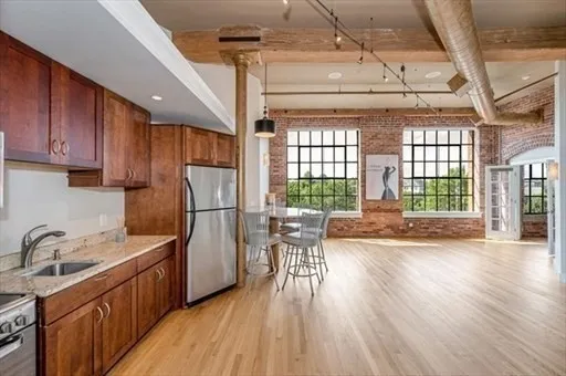 a kitchen with sink cabinets and wooden floor
