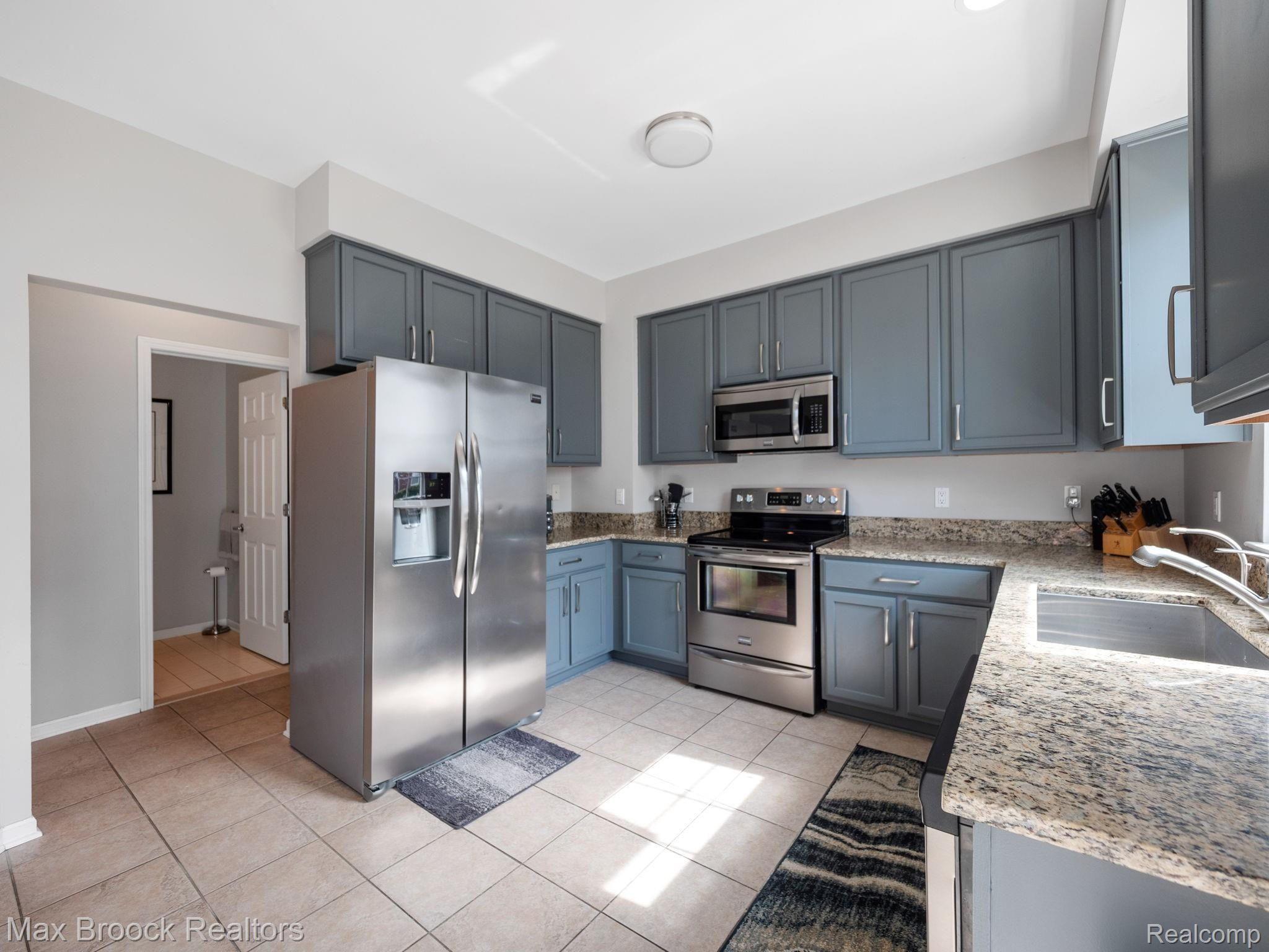 41491 Mitchell Road Novi, MI 48377 - Photo 6 of 28 Kitchen boasts many cabinets for storage and quartz counter tops.