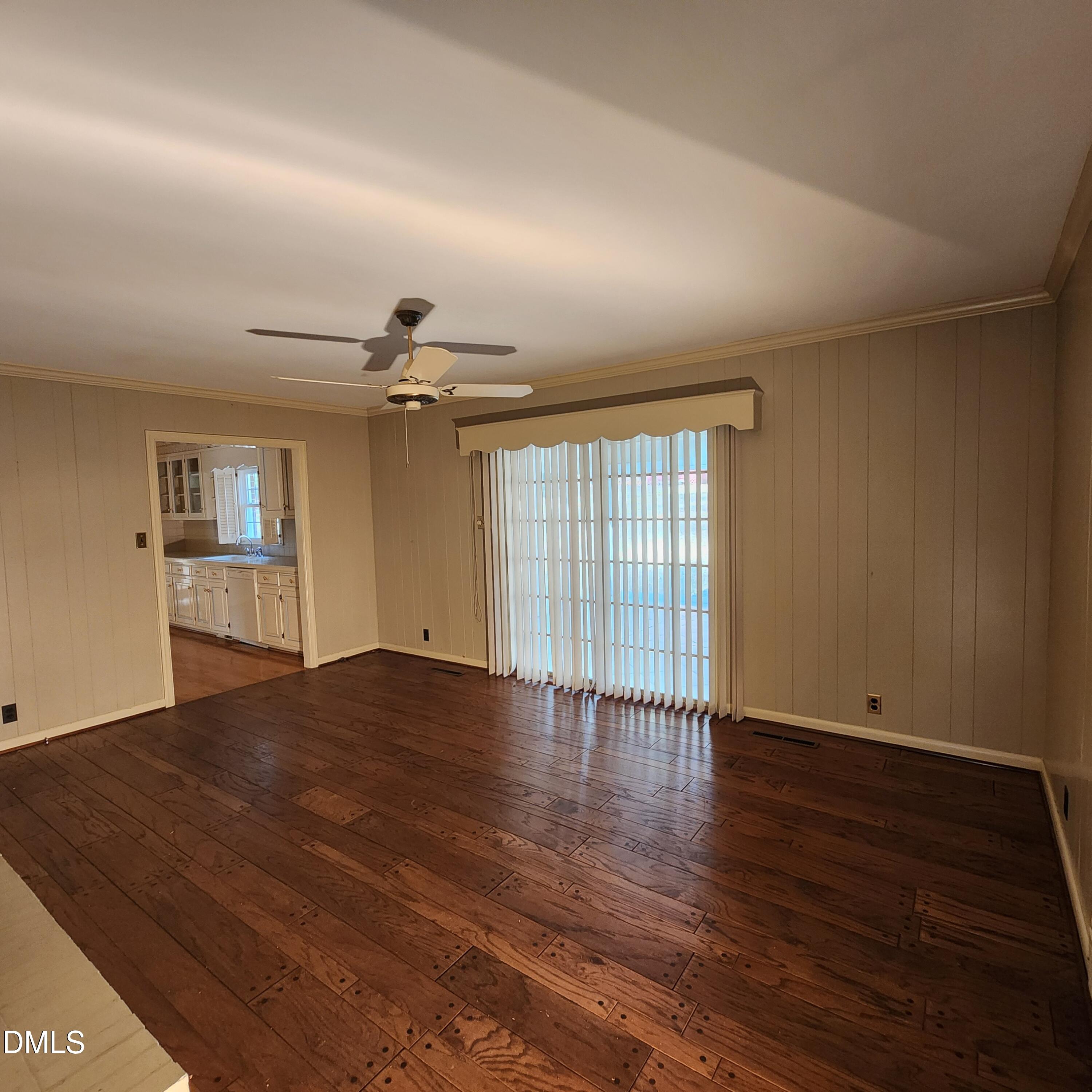 744 Durham Road Wake Forest, NC 27587 - Photo 11 of 25 an empty room with wooden floor chandelier and windows