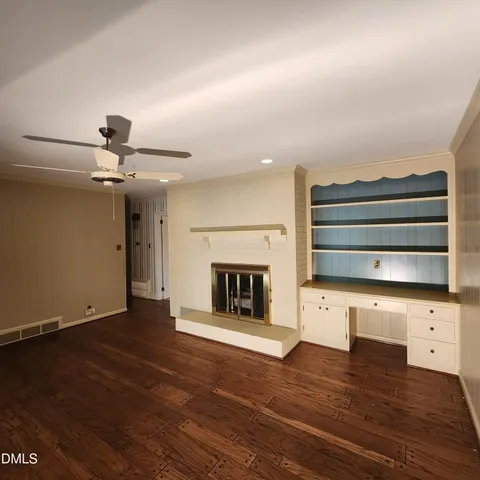 wooden floor in an empty room with a fireplace