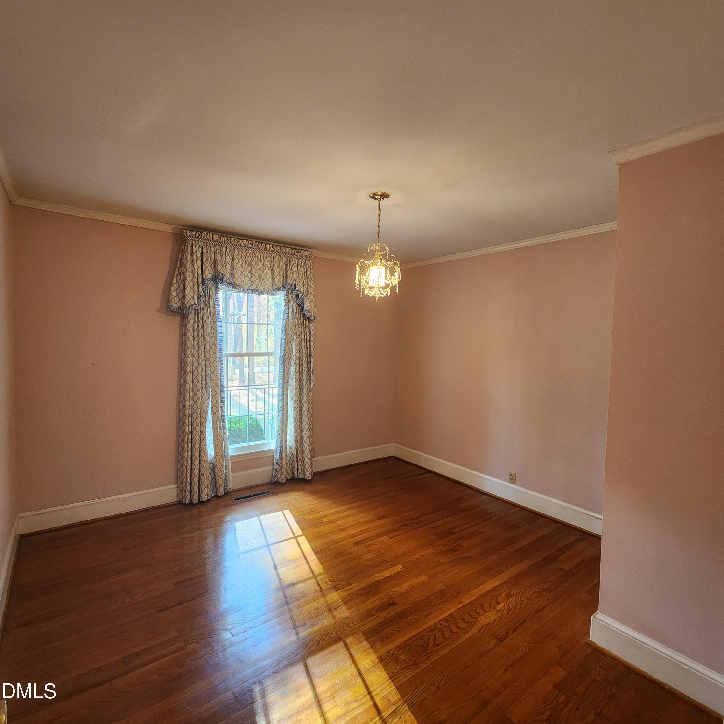 744 Durham Road Wake Forest, NC 27587 - Photo 14 of 25 an empty room with wooden floor and windows