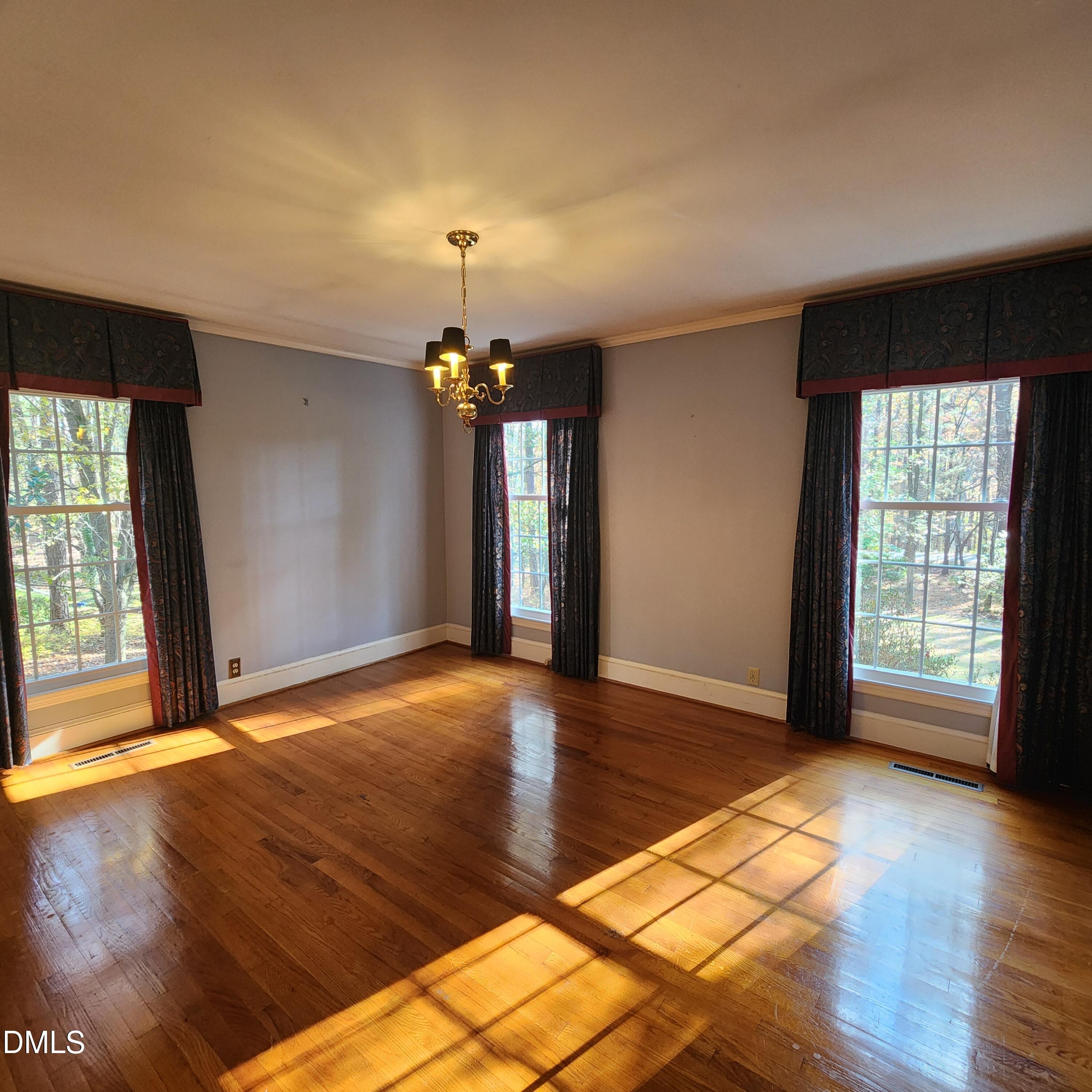 744 Durham Road Wake Forest, NC 27587 - Photo 15 of 25 an empty room with wooden floor and windows