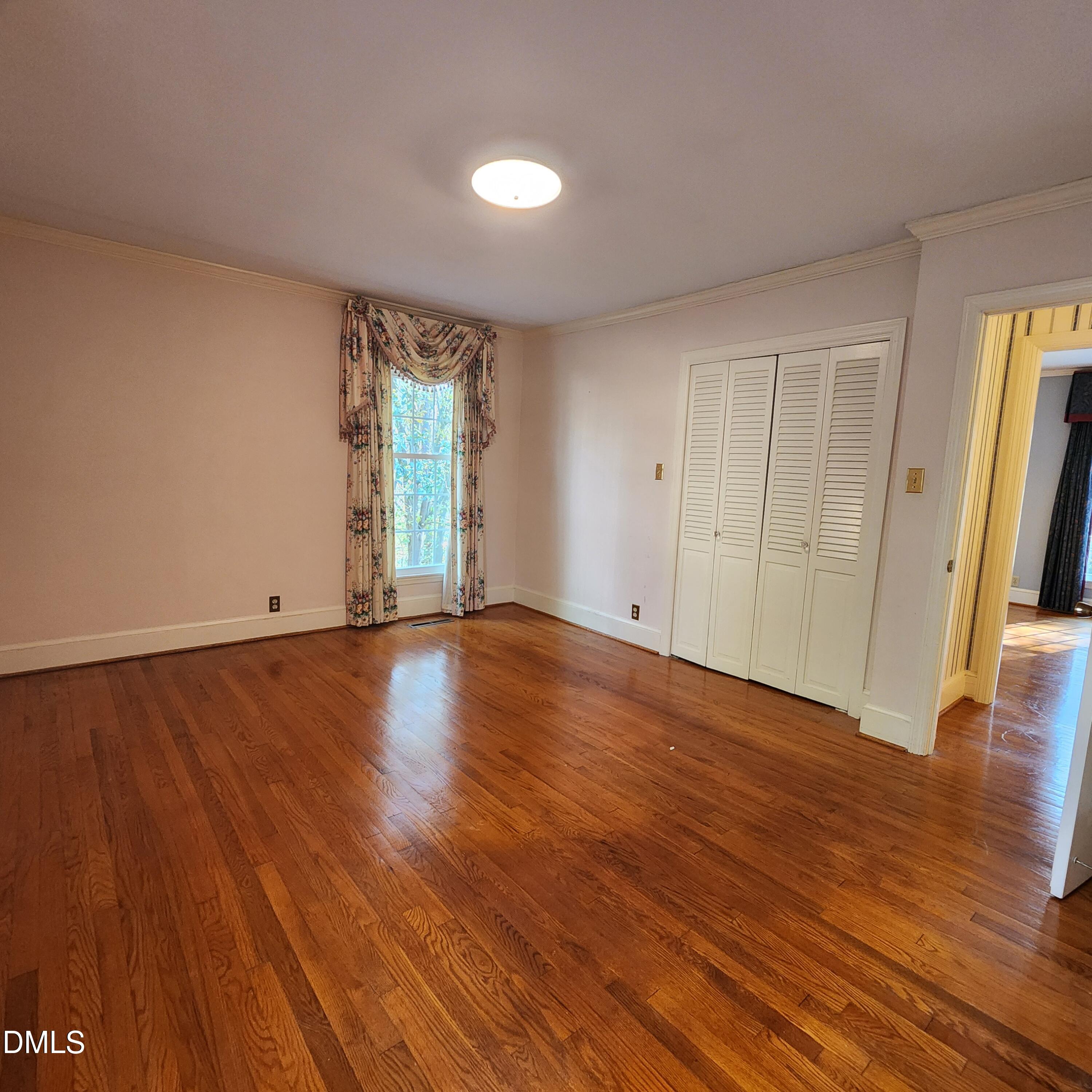 744 Durham Road Wake Forest, NC 27587 - Photo 19 of 25 an empty room with wooden floor and windows
