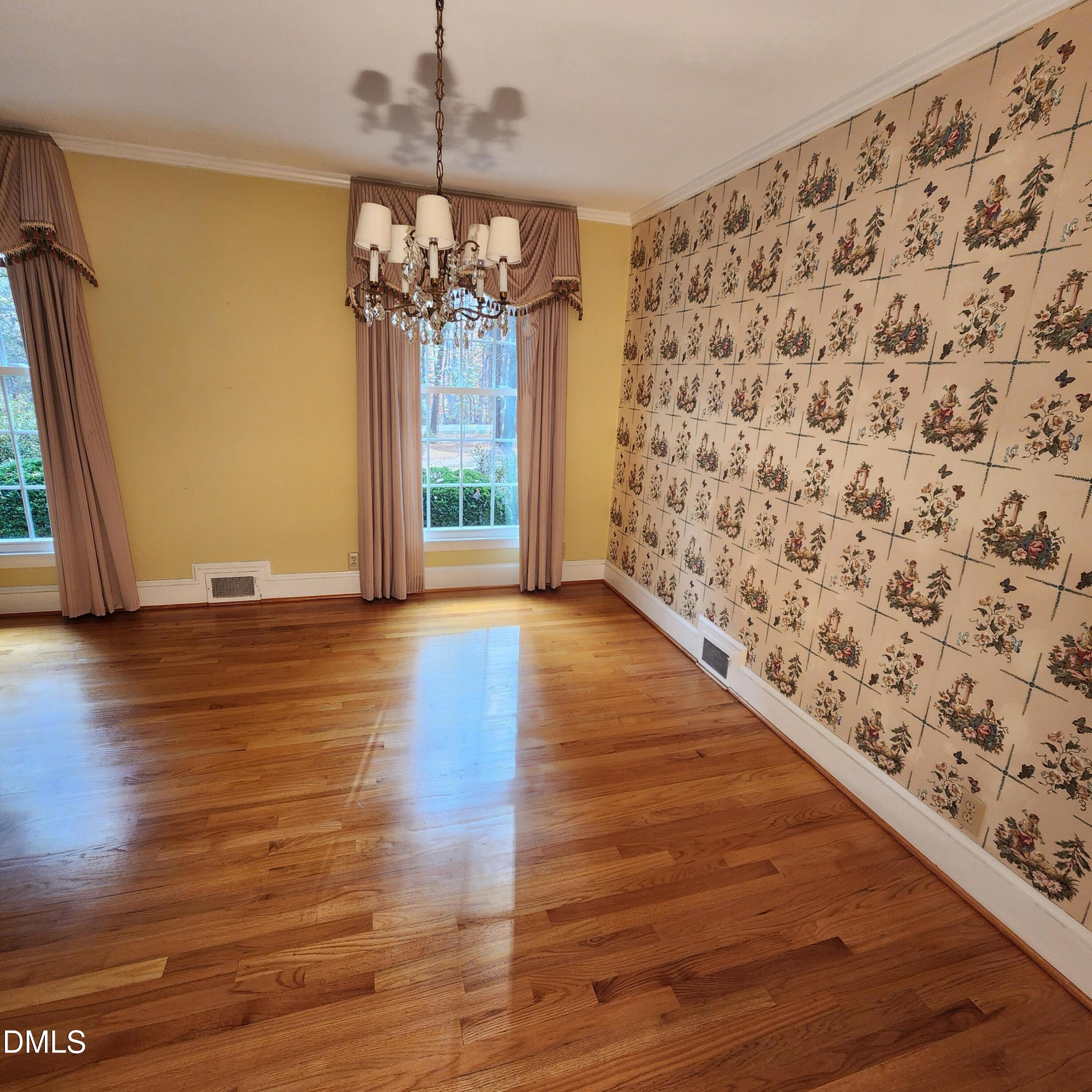 744 Durham Road Wake Forest, NC 27587 - Photo 6 of 25 a view of a hallway with wooden floor and a chandelier