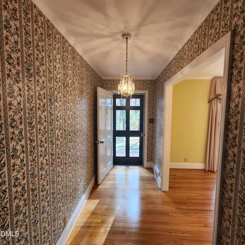 a view of entryway with window and wooden floor