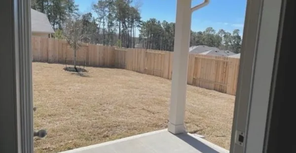 a view of a balcony with yard