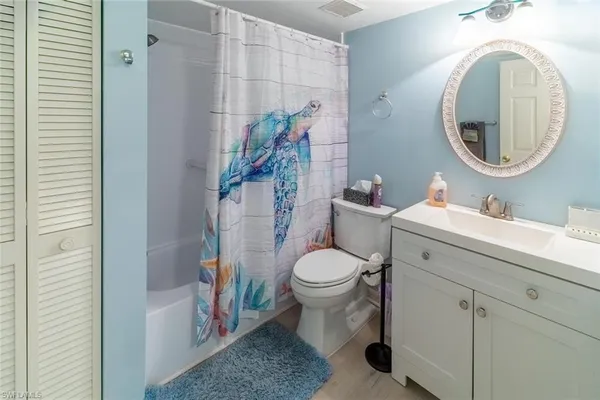 a bathroom with a toilet a sink and a mirror