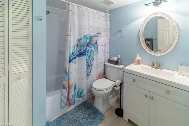 a bathroom with a toilet a sink and a mirror