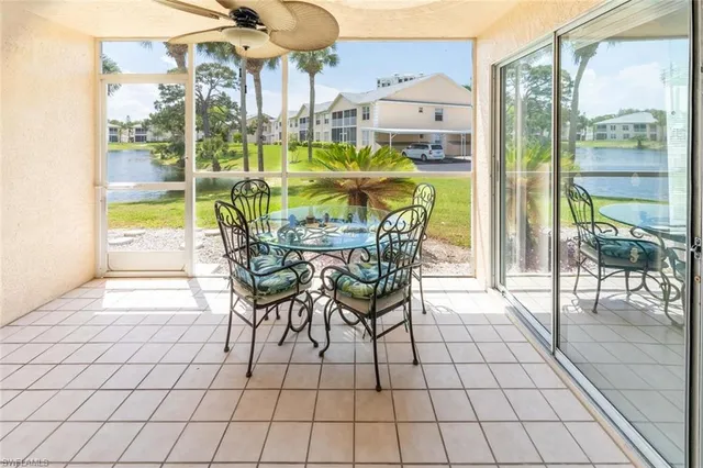 a view of a dining area with furniture and floor to ceiling window