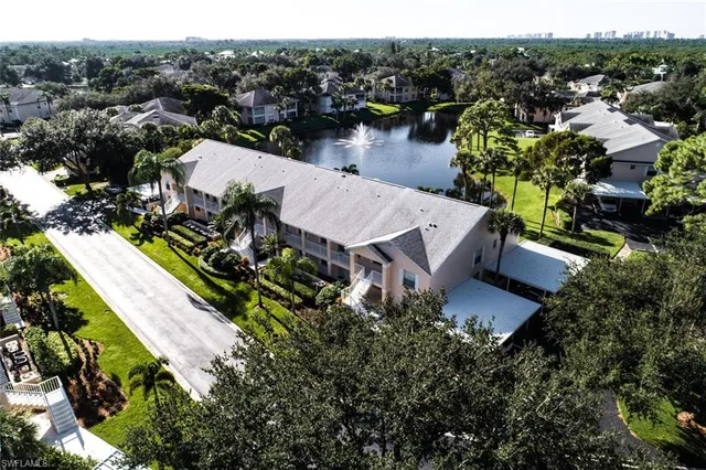 an aerial view of a house with a garden and lake view