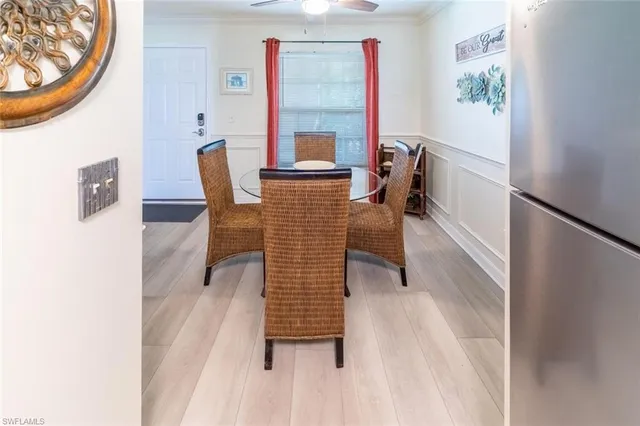 a view of a dining room with furniture and a window