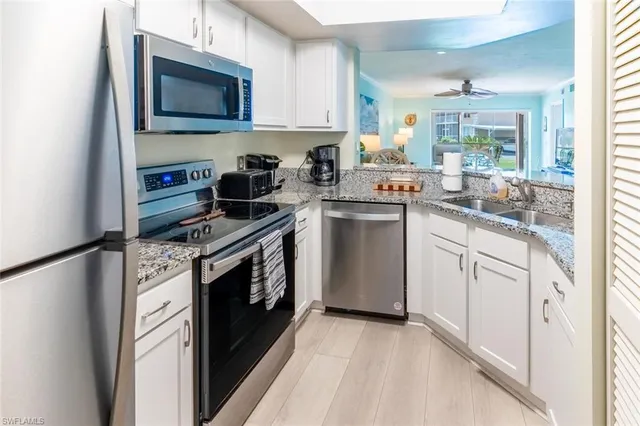 a kitchen with a stove microwave and sink