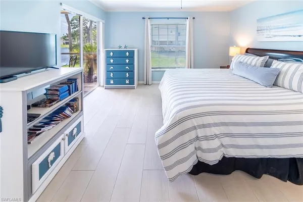 a bedroom with a bed and a book shelf