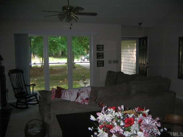 3525 Singleleaf Lane Raleigh, NC 27616 - Photo 3 of 10 Enjoy the large windows overlooking your wooded front lawn by day and the cozy gas log fireplace by night.