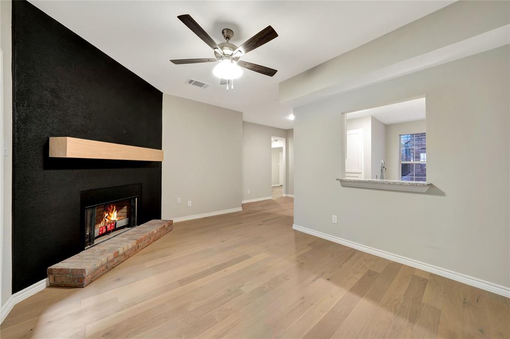 a view of empty room with a fireplace