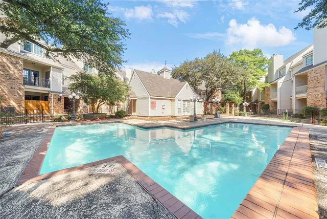 a view of a swimming pool with a patio