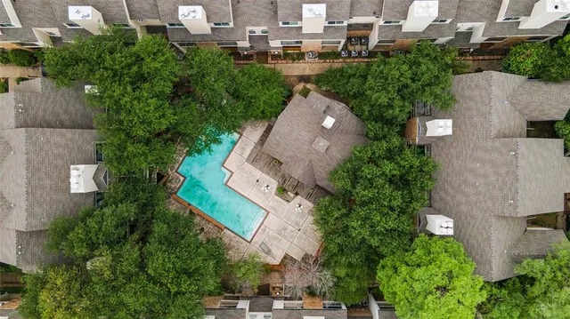 an aerial view of multiple houses with yard
