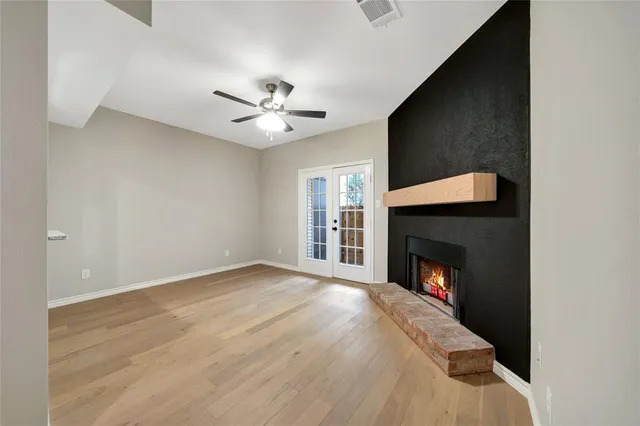 a view of empty room with a fireplace