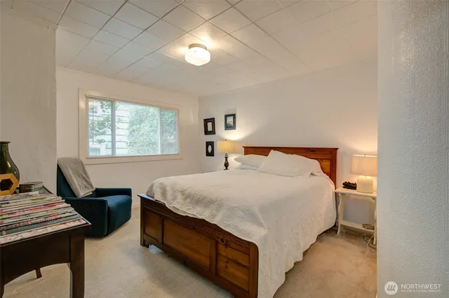 a bedroom with a bed and window