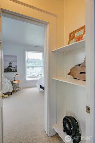 a bed sitting in a bedroom next to a window