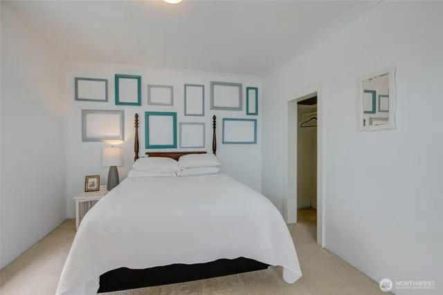 a bedroom with a bed and large window