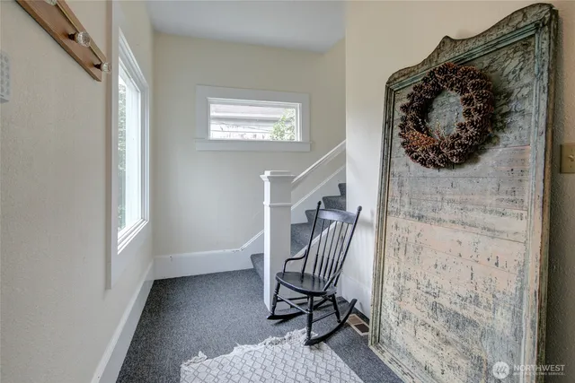 a view of entryway with a rug and wooden floor