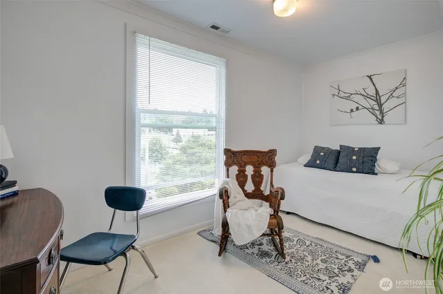 a bedroom with furniture and a potted plant