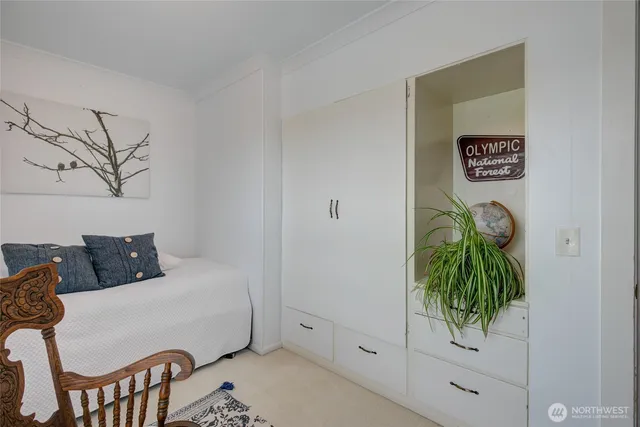 a bed sitting in a bedroom next to a window