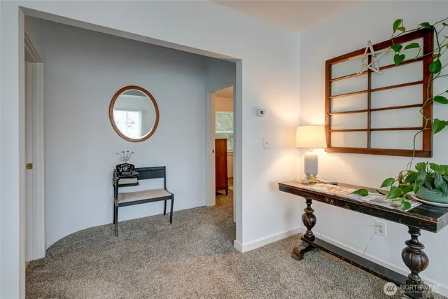 a room with a table chair and a window