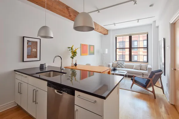a kitchen with a sink a counter space and dining table