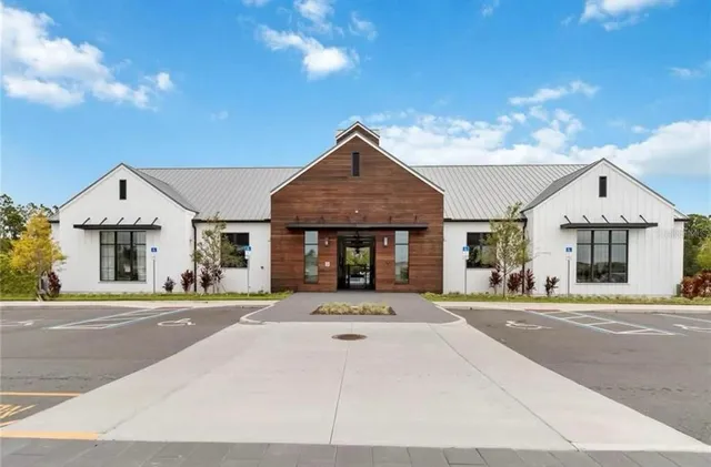aerial view of a swimming pool with outdoor seating and yard