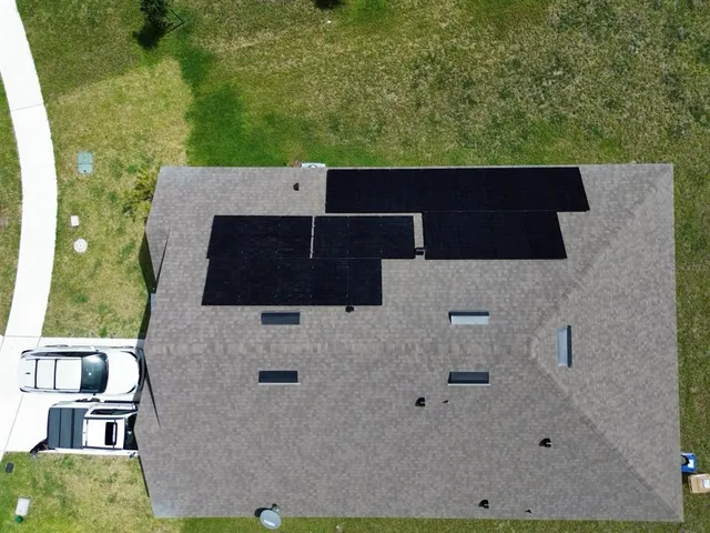 an aerial view of house with yard