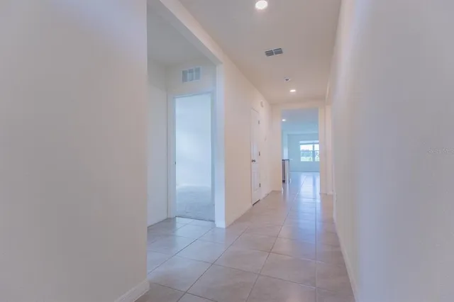 a view of a hallway with a bathroom