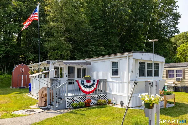a front view of a house with swimming pool and porch