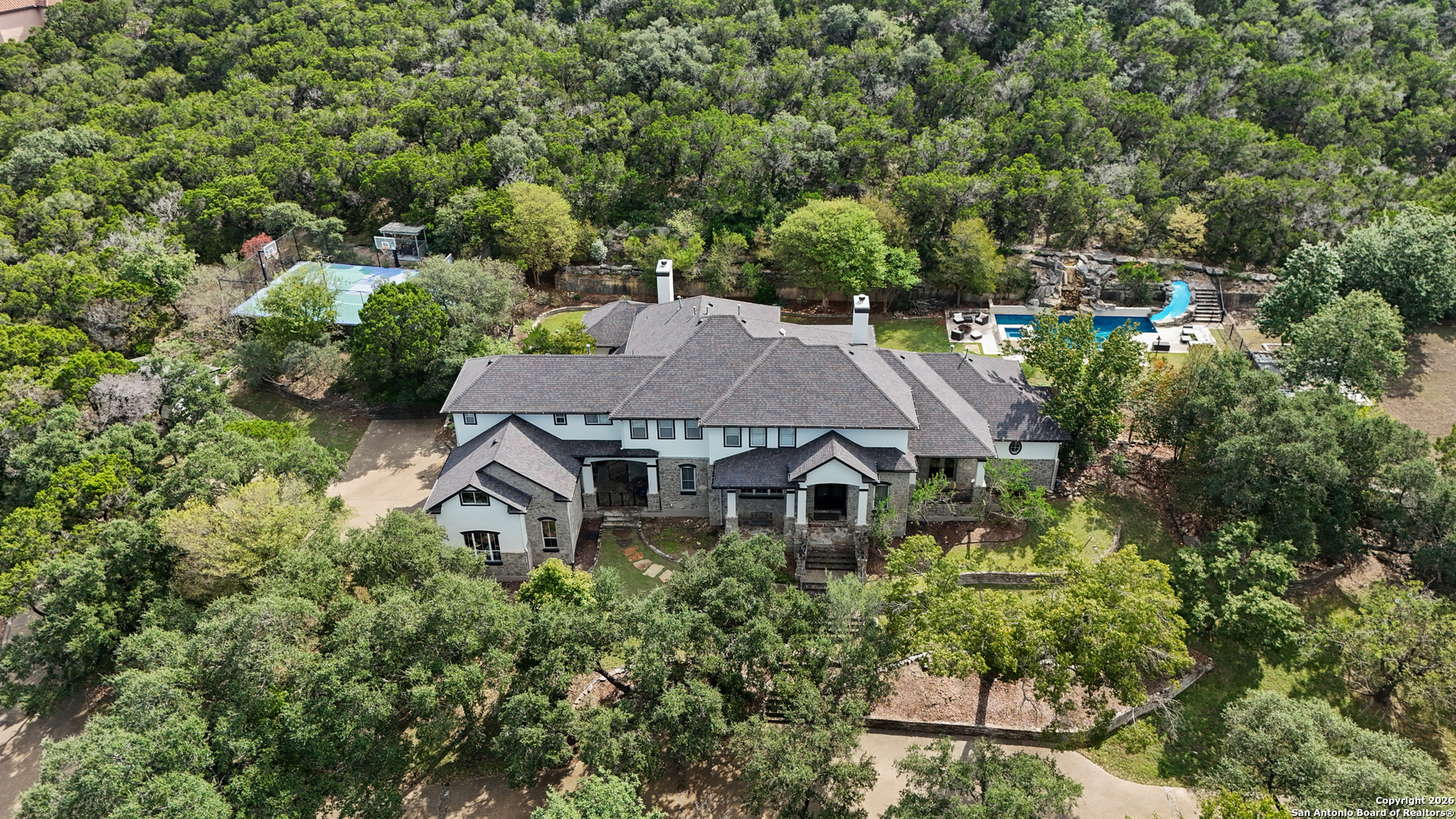 an aerial view of a house with yard porch and furniture