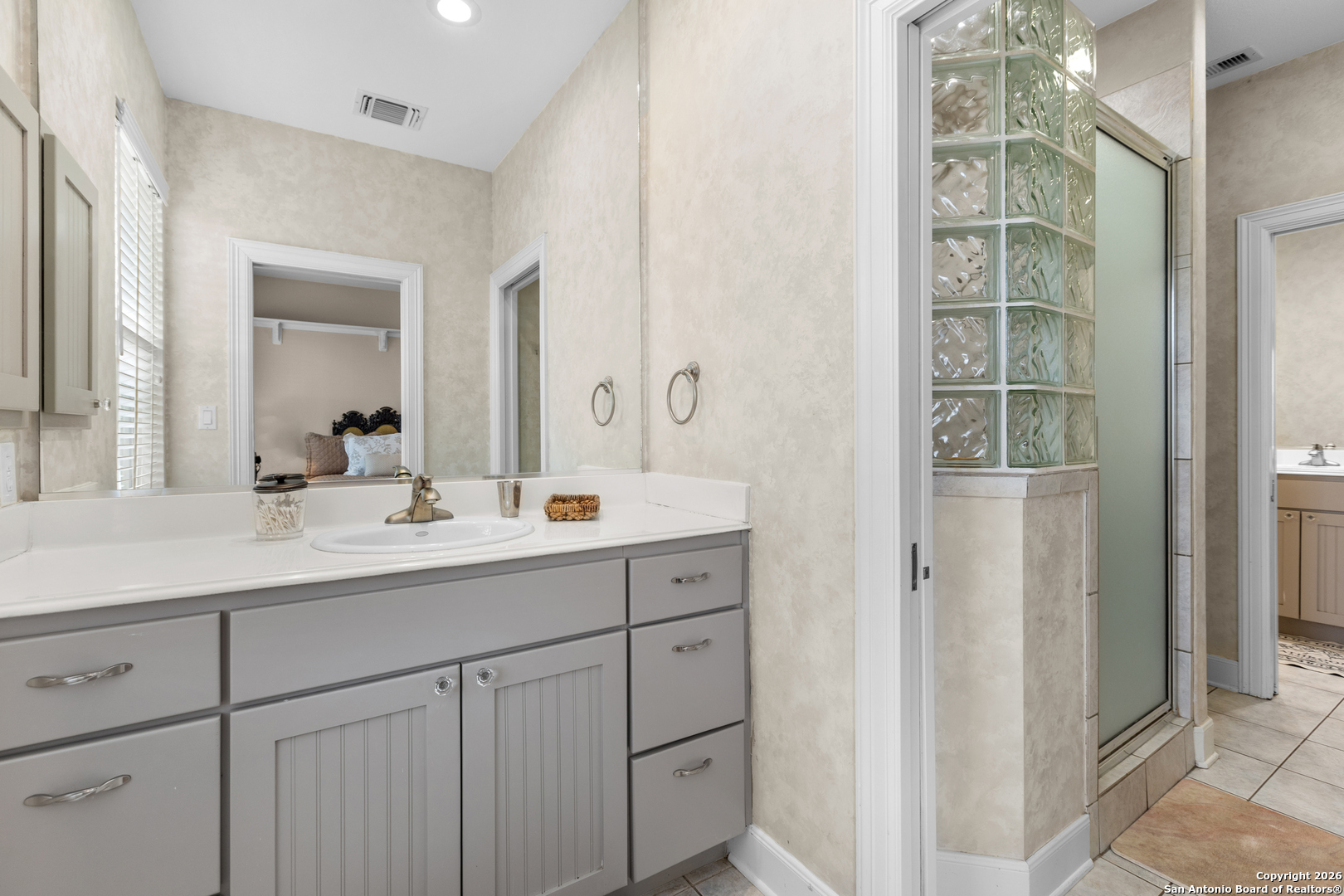 10924 Reyes Canyons Helotes, TX 78023 - Photo 45 of 61 a bathroom with a double vanity sink and mirror